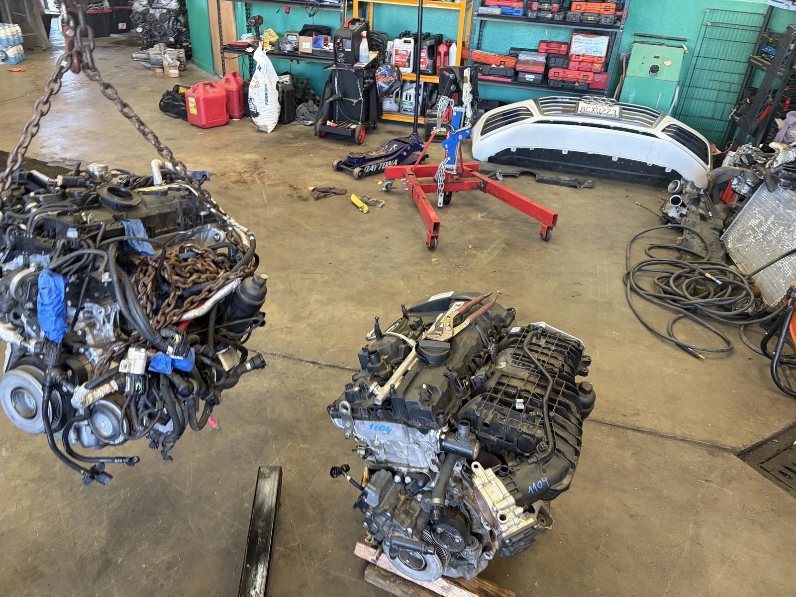 Two engines out on the floor of the Supercanic shop in San Jacinto