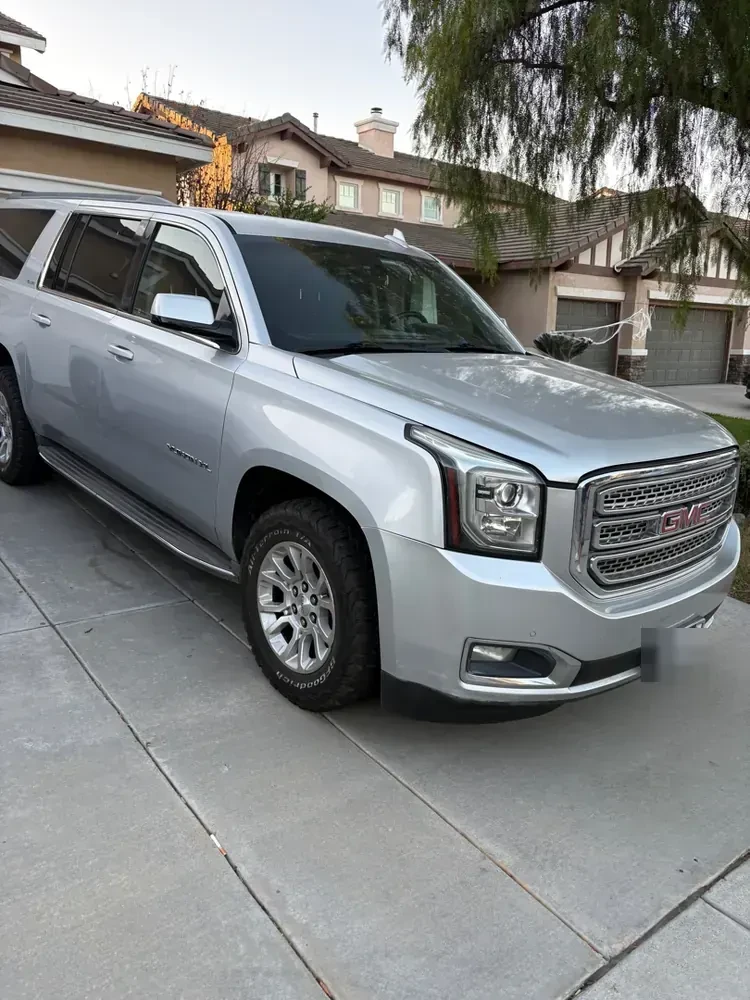 A GMC Yukon parked in a Menifee driveway before a mobile repair